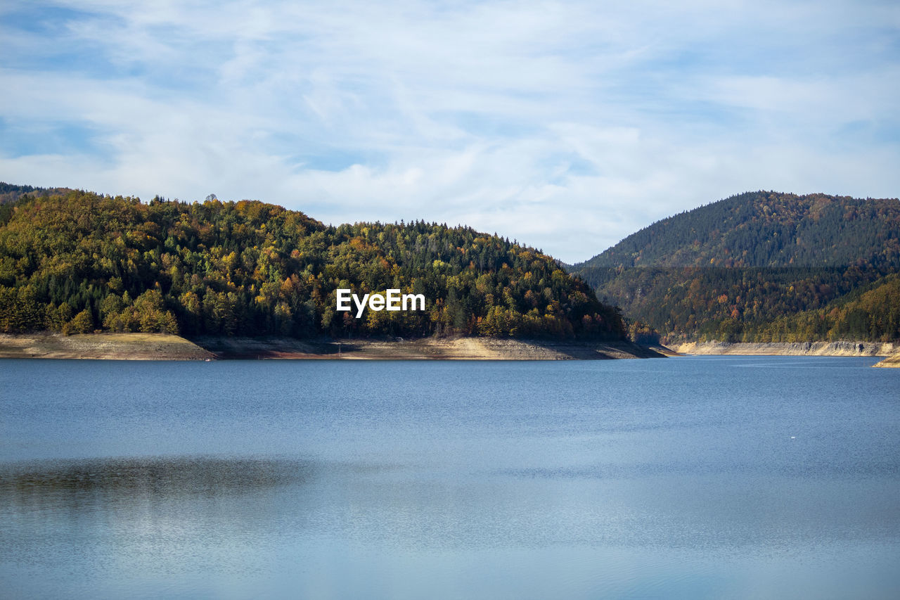 Scenic view of lake and mountains against sky