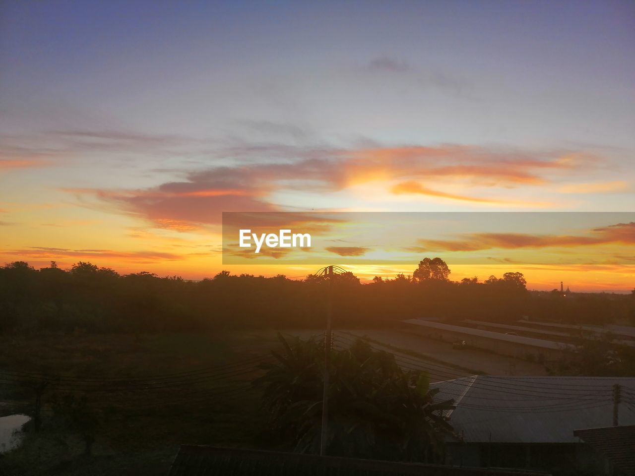 SCENIC VIEW OF FIELD AGAINST ORANGE SKY DURING SUNSET