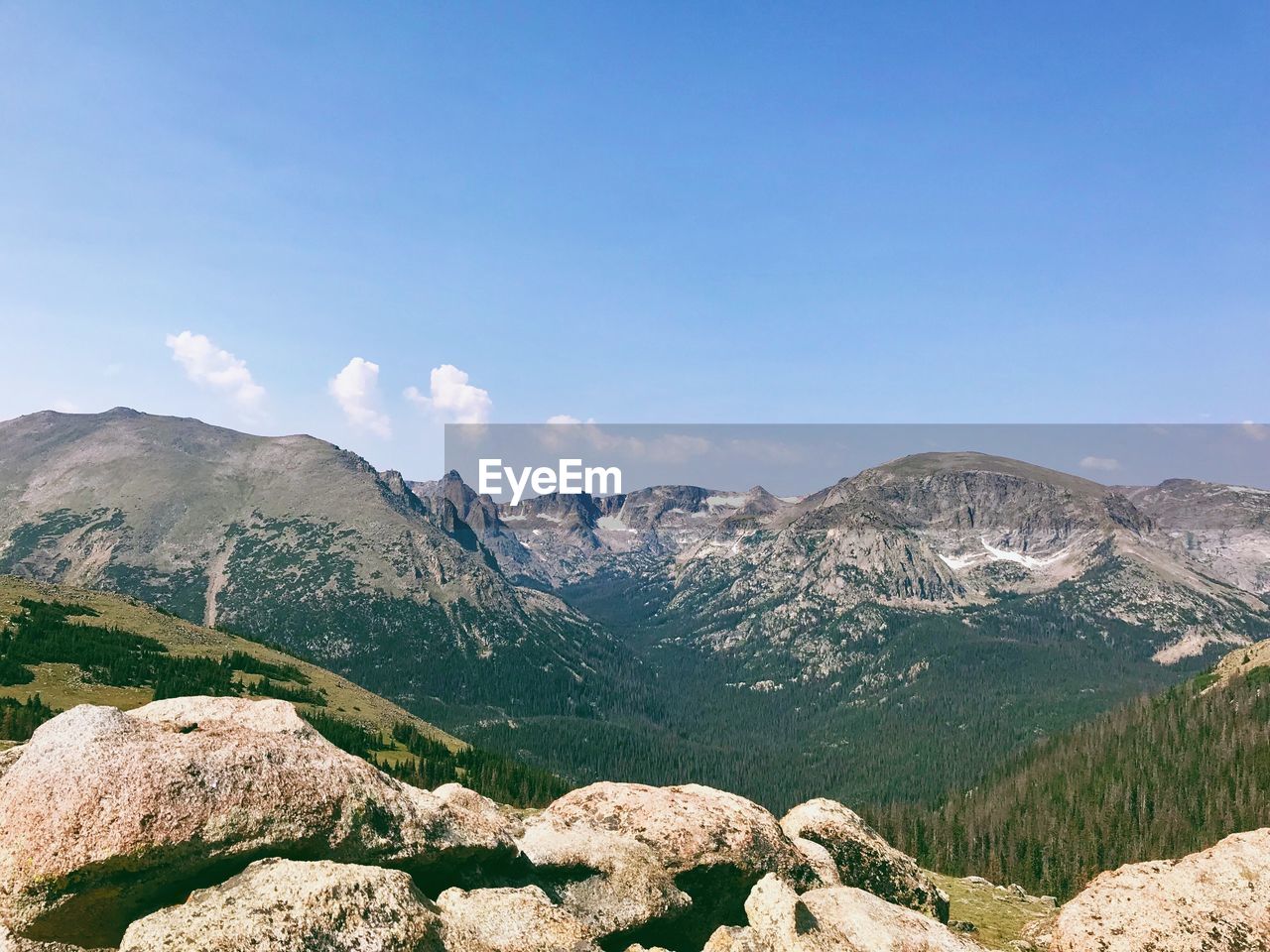 Scenic view of mountains against blue sky