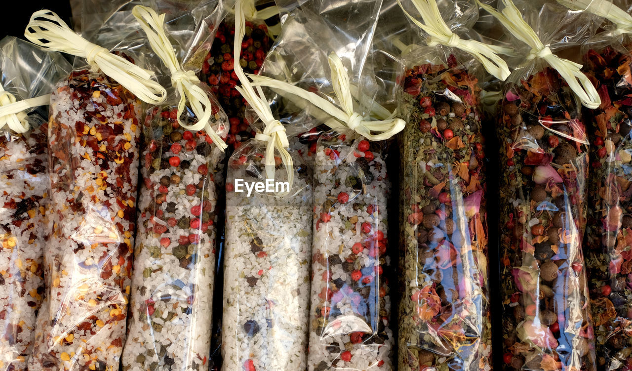 Colourful various italian herbs and spices in beautiful small transparent wrapping bags for sale.