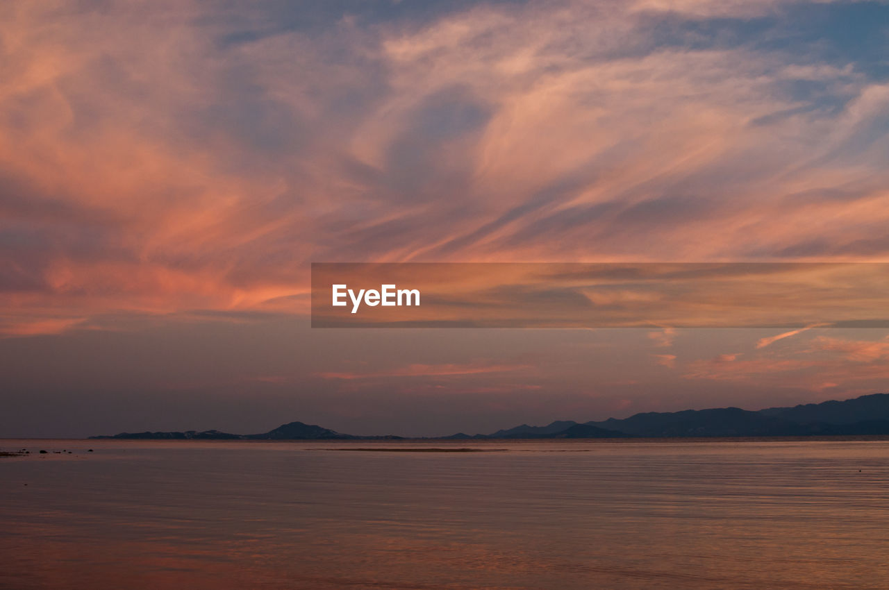 Scenic view of sea against orange sky