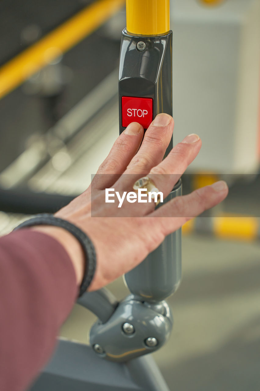 Man push with his finger the stop button