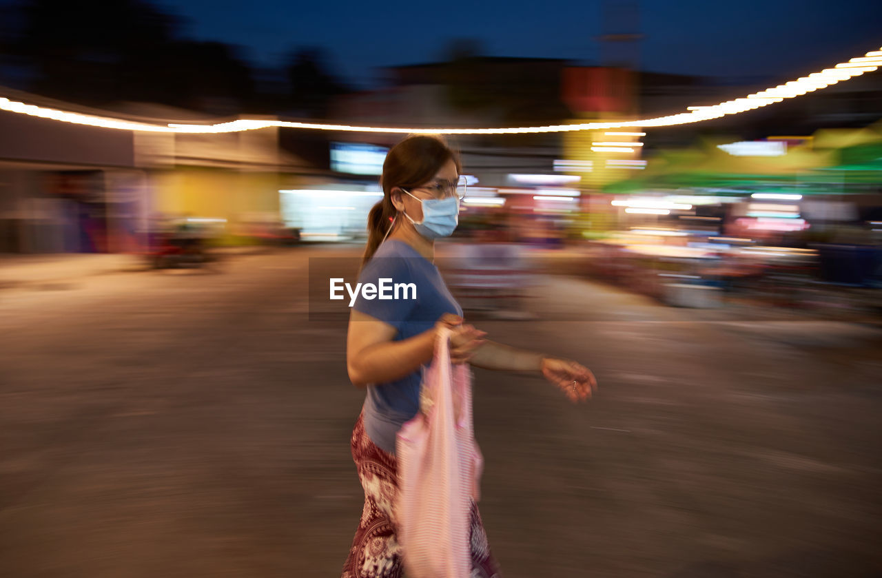 Blur motion of woman walking in the market during covid-19 disease