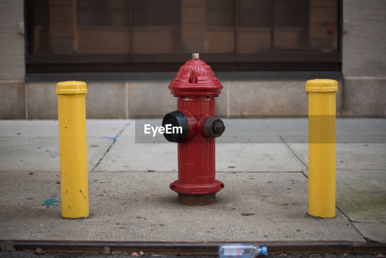 Close-up of fire hydrant at sidewalk