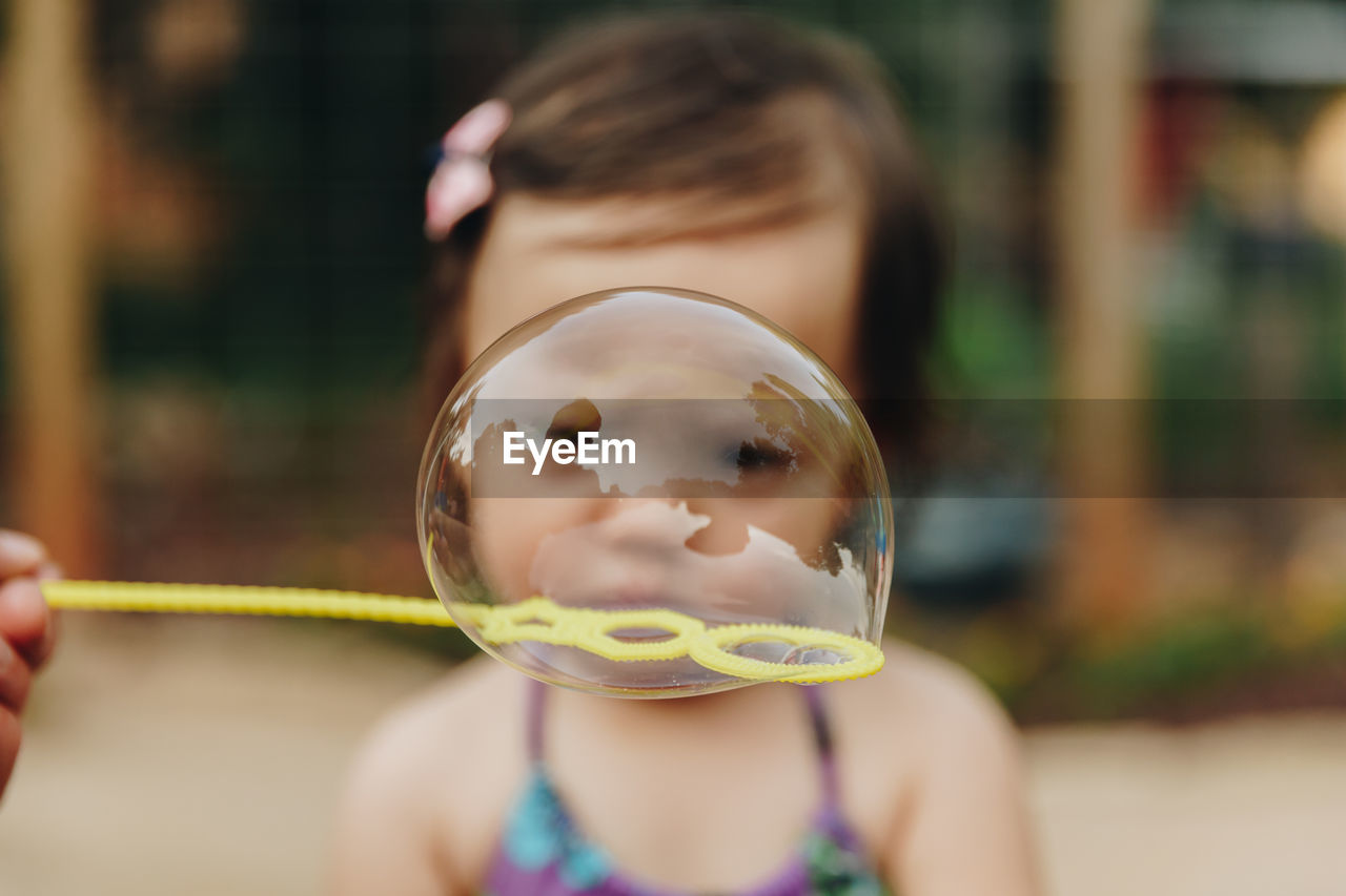 Close-up of girl seen through bubble