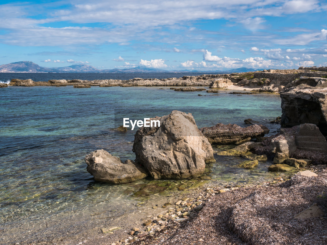 SCENIC VIEW OF ROCKS AGAINST SKY