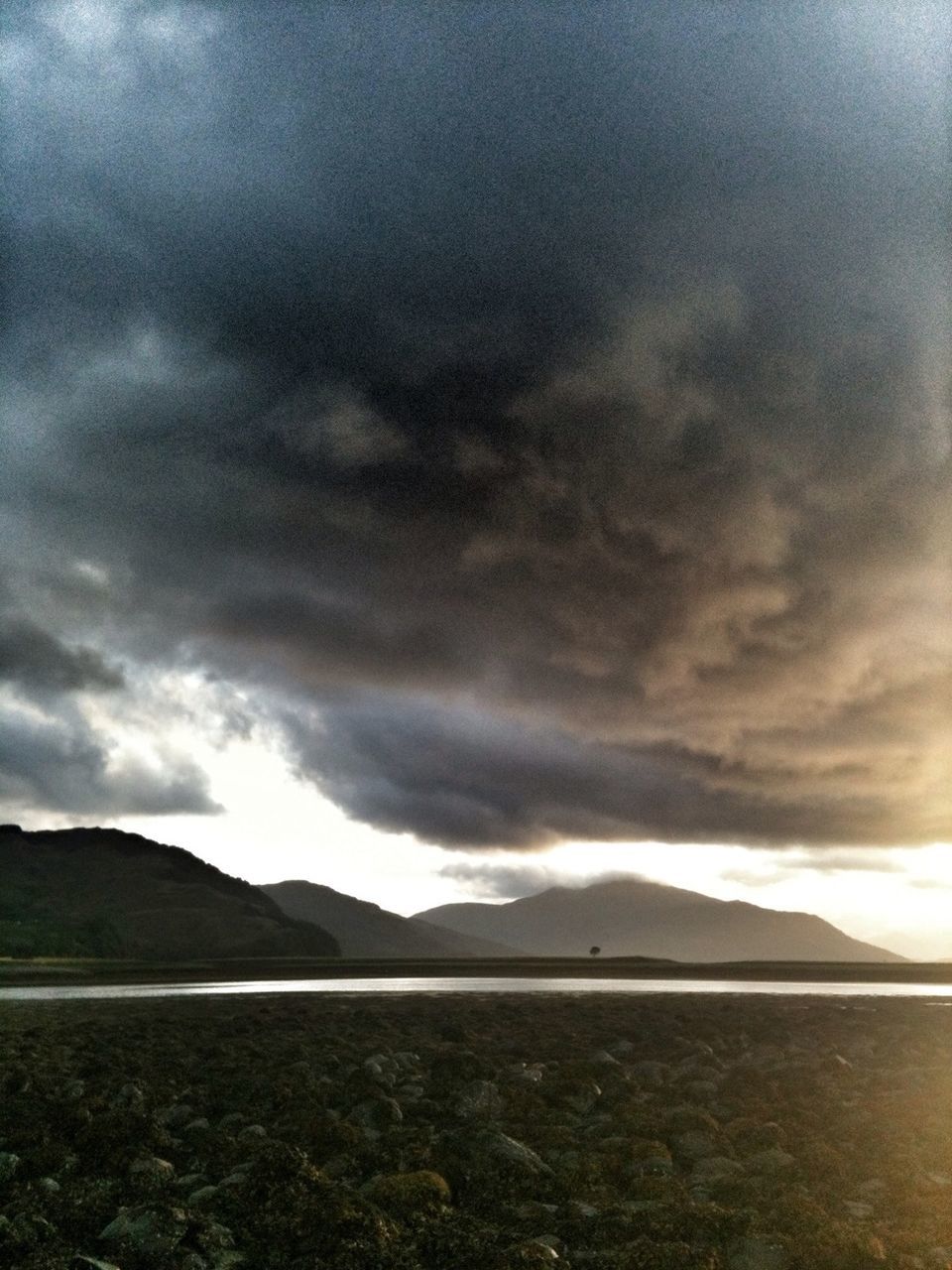 SCENIC VIEW OF MOUNTAINS AGAINST CLOUDY SKY