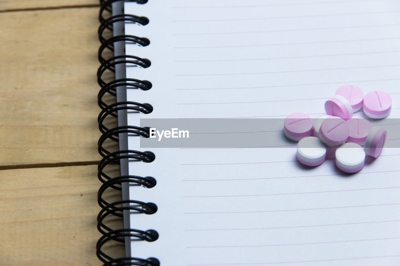 Close-up of book and pills on table