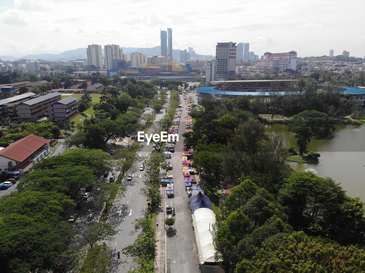 architecture, city, built structure, building exterior, building, cityscape, high angle view, aerial photography, transportation, sky, tree, metropolitan area, nature, street, road, bird's-eye view, residential area, plant, landscape, residential district, mode of transportation, office building exterior, motor vehicle, car, urban skyline, skyscraper, urban area, skyline, travel destinations, cloud, city life, city street, water, outdoors, town, traffic, travel, neighbourhood, no people, aerial view, day, downtown, landmark, downtown district, tower
