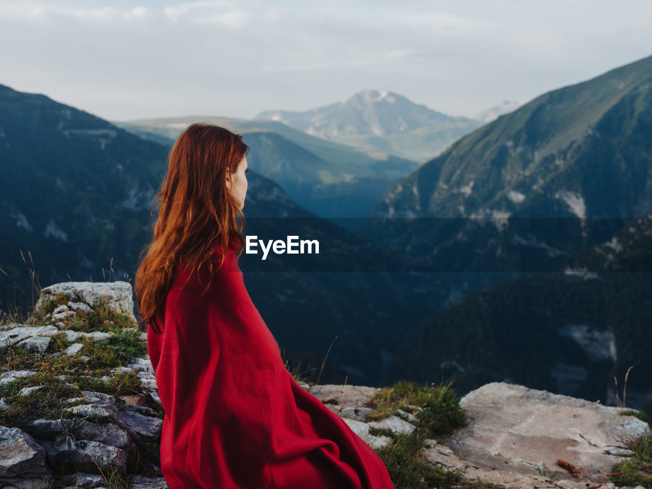 WOMAN LOOKING AT MOUNTAINS