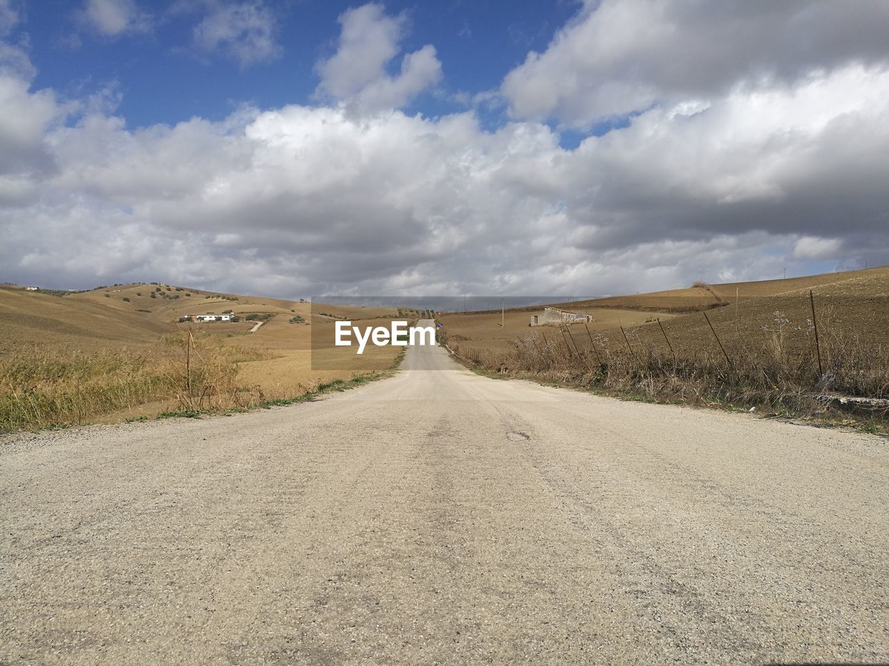 Empty road along countryside landscape