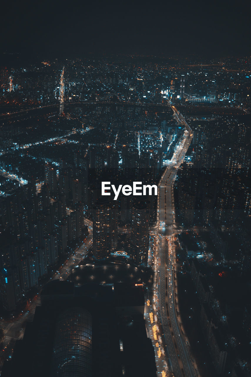 Aerial view of illuminated city buildings at night