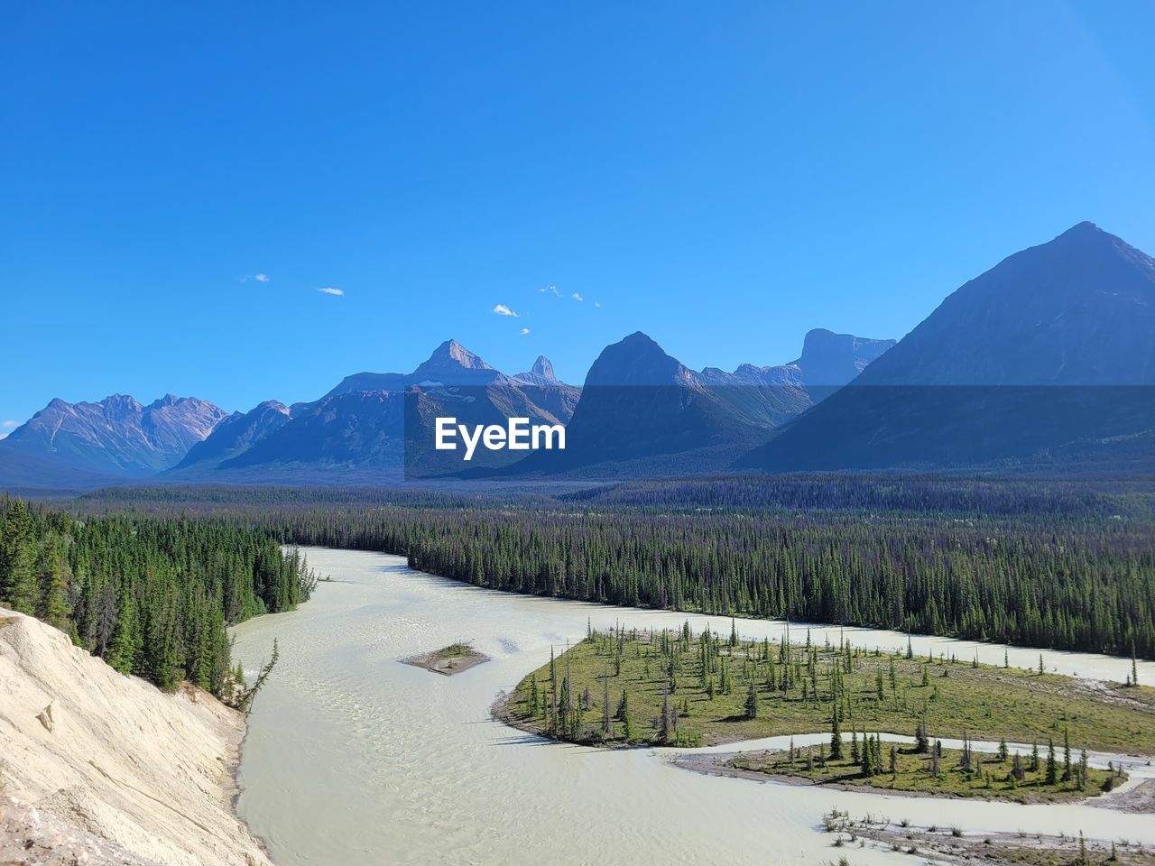 SCENIC VIEW OF LAKE AND MOUNTAINS AGAINST BLUE SKY