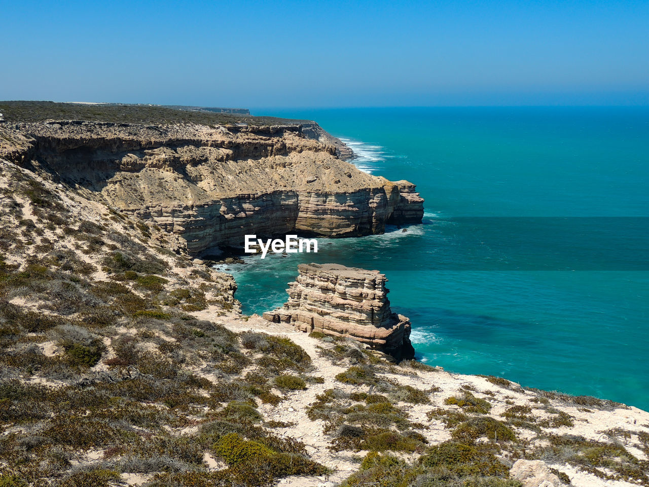 Scenic view of sea and rocks against sky