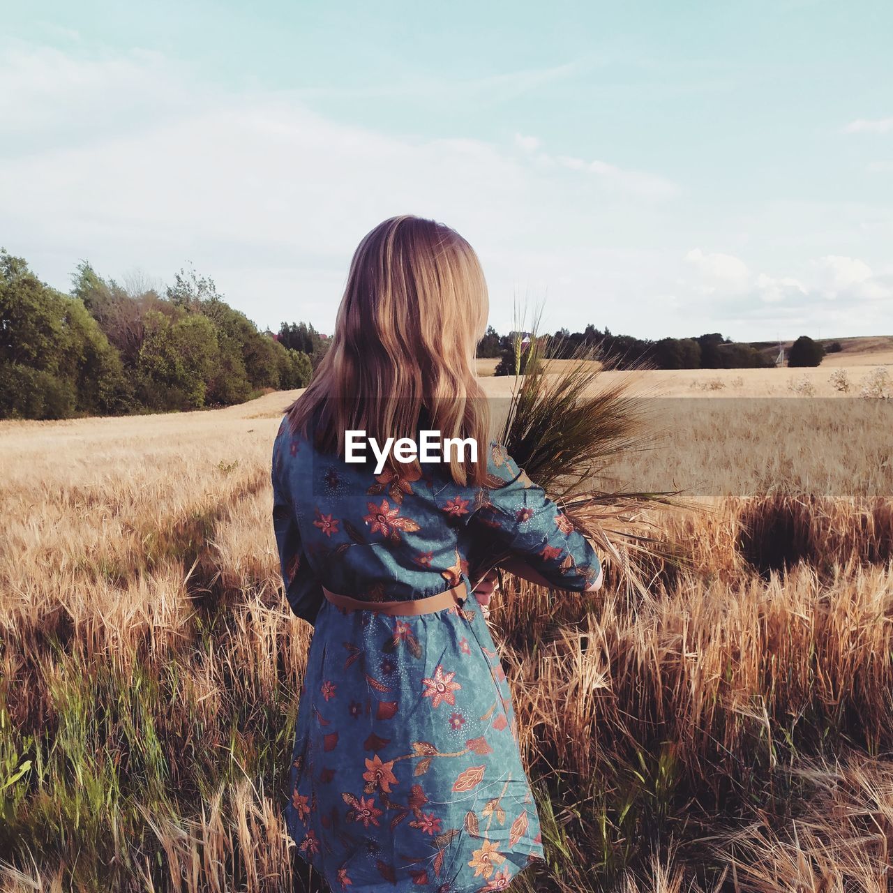 WOMAN STANDING IN FIELD