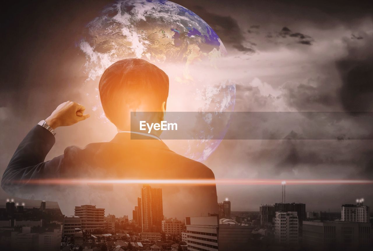 Digital composite image of businessman with cityscape and planet earth