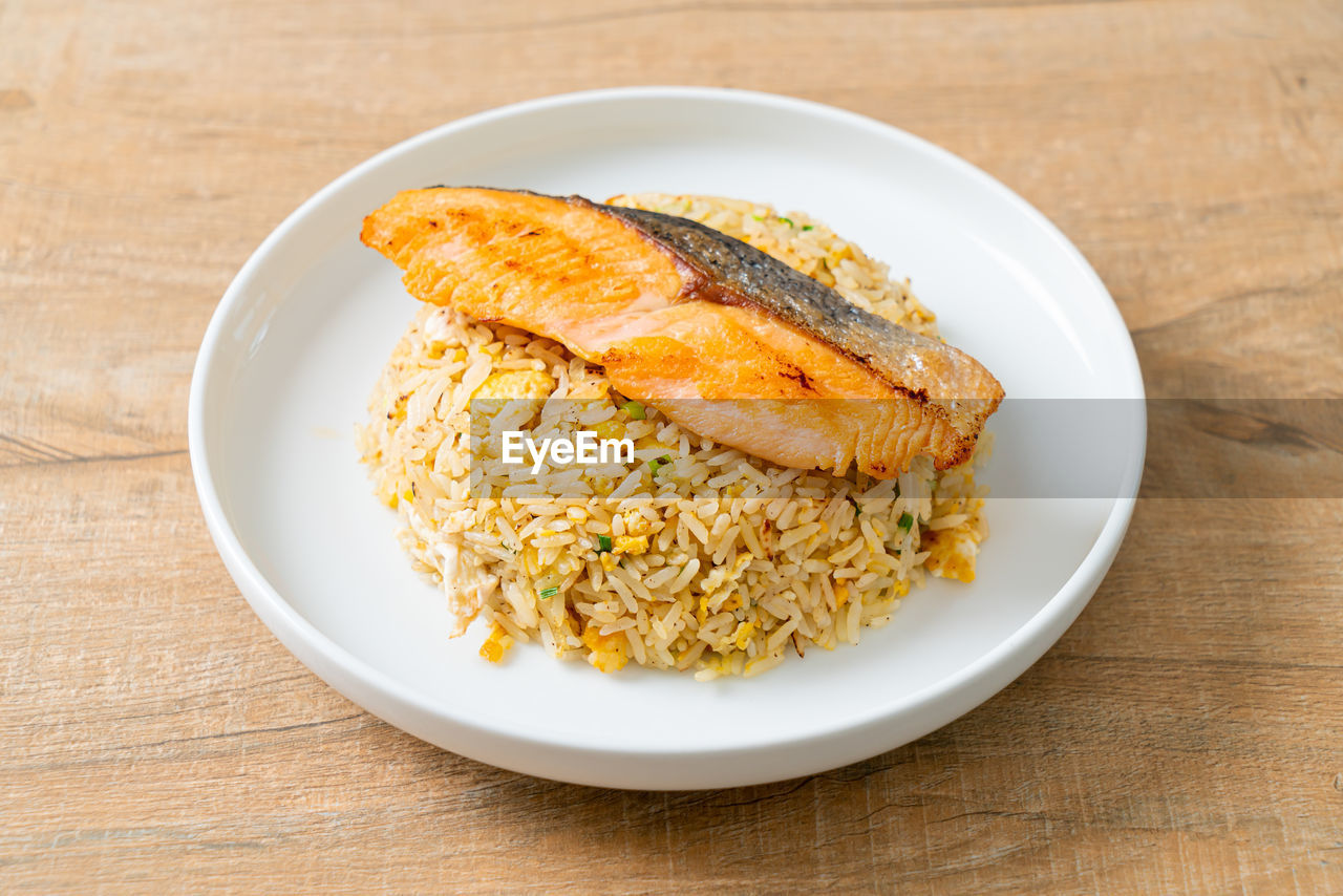 food and drink, food, healthy eating, plate, wellbeing, dish, wood, freshness, produce, meal, table, no people, rice - food staple, fish, indoors, rice, vegetable, studio shot, crockery, breakfast, cuisine, high angle view, fried rice, asian food, animal, close-up