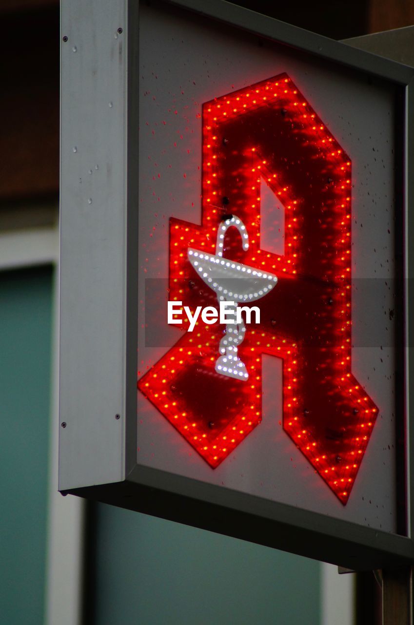 CLOSE-UP OF ILLUMINATED TEXT ON RED LIGHT