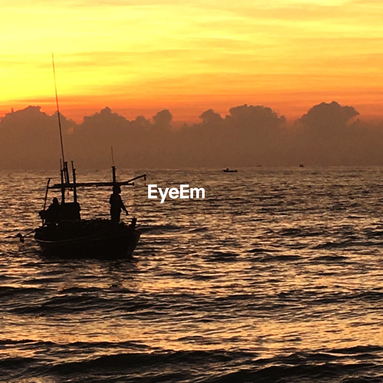 SILHOUETTE SAILBOATS IN SEA AGAINST ORANGE SKY