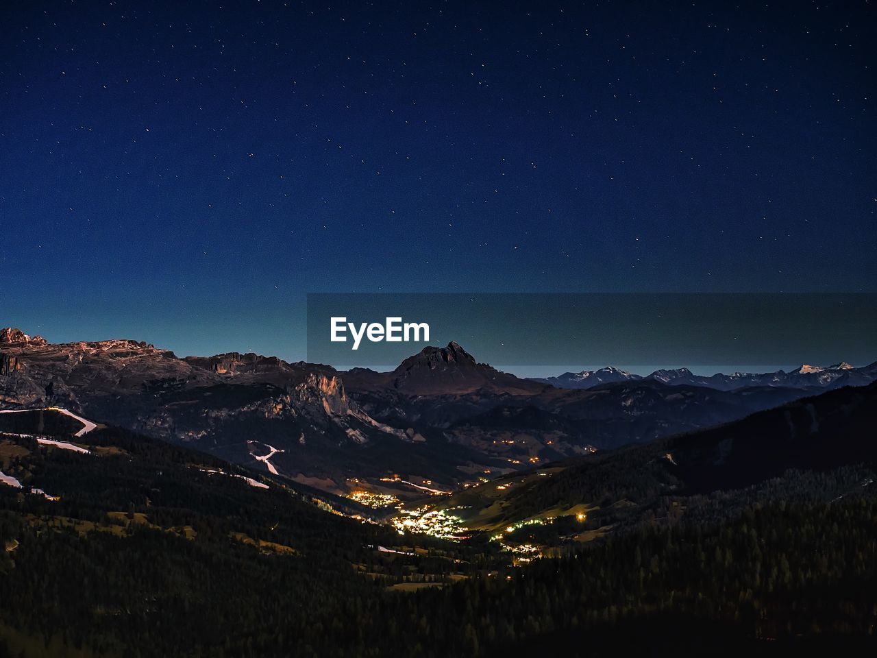 Scenic view of mountains against sky at dusk