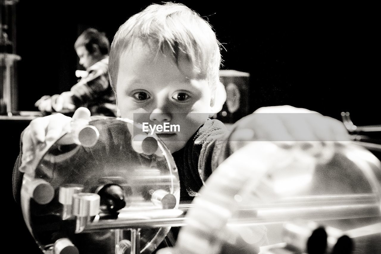 Little boy playing with machinery in laboratory