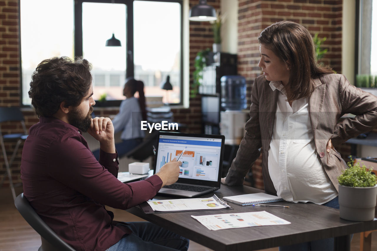 Business colleagues talking in office