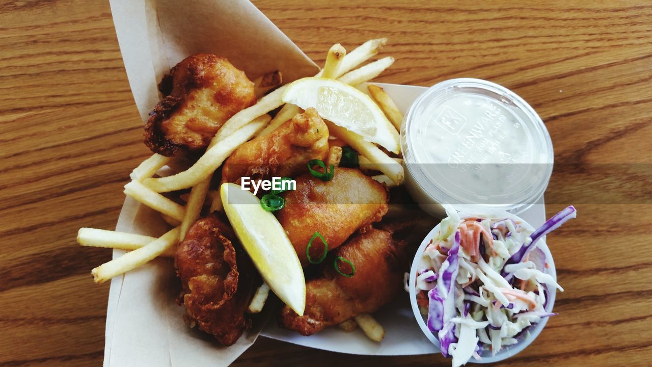 Plate of fish and chips served with salad