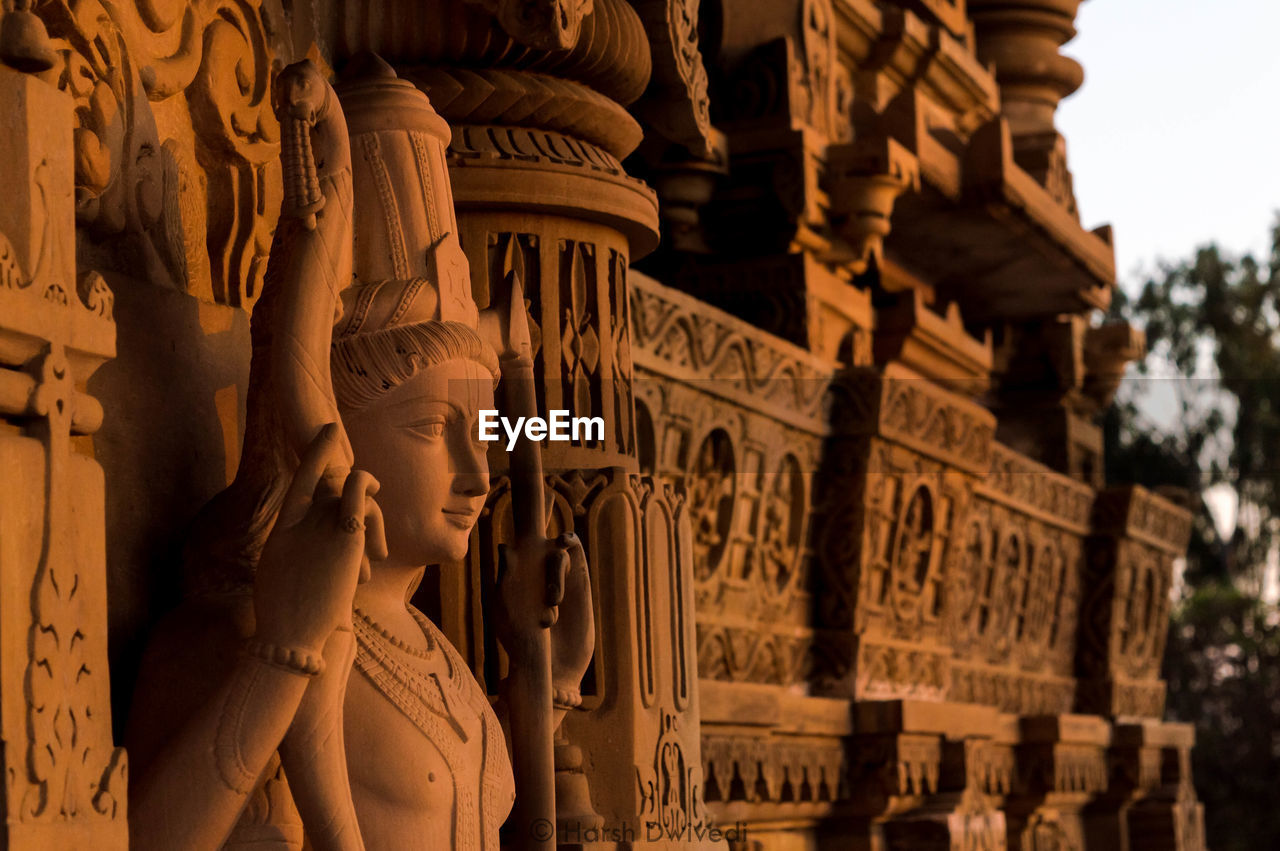 LOW ANGLE VIEW OF BUDDHA STATUE