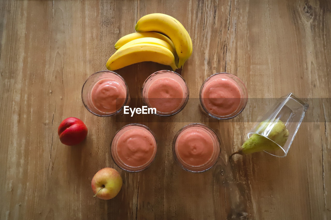 HIGH ANGLE VIEW OF FRUITS ON WOODEN TABLE