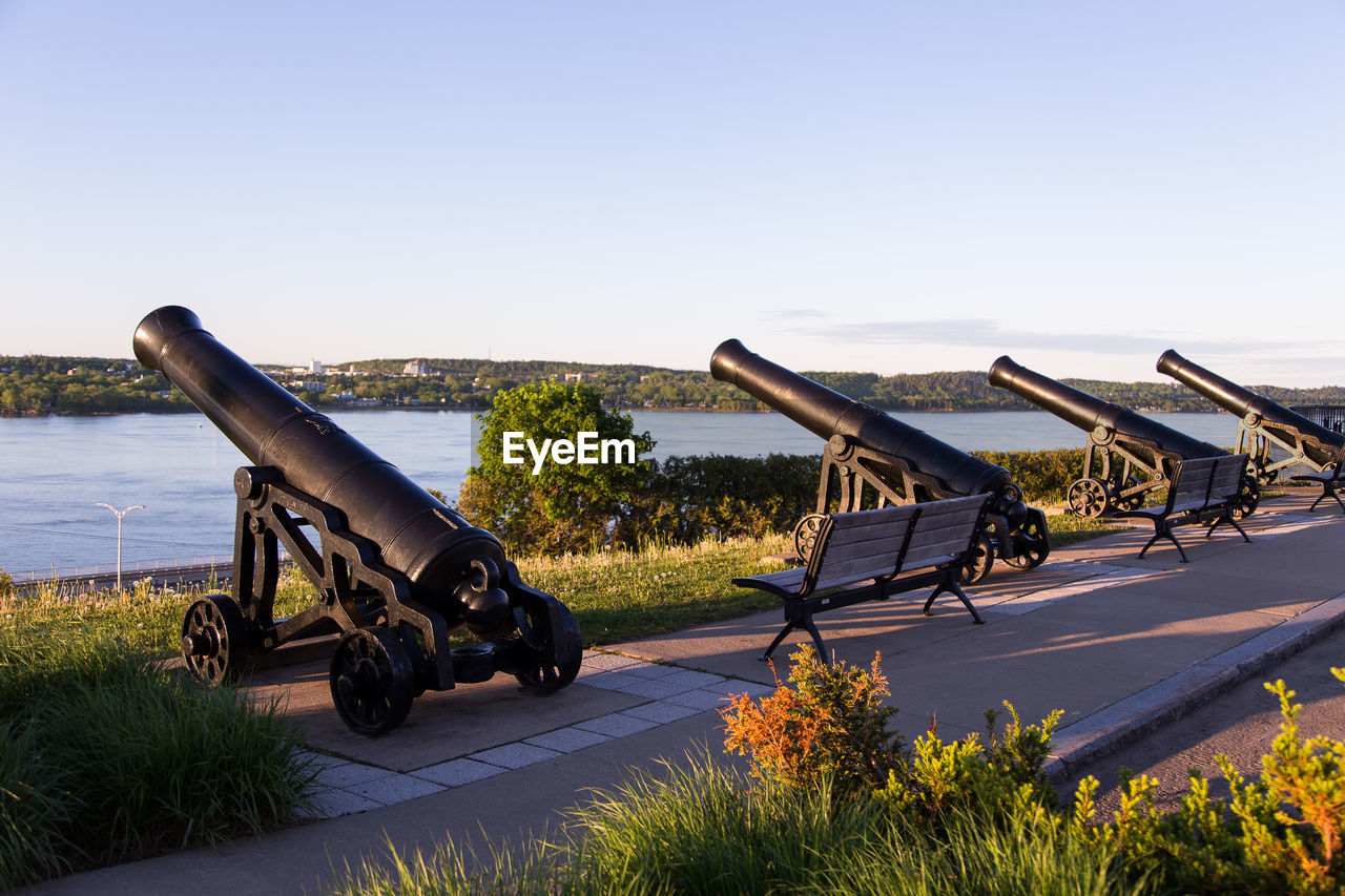 Row of old cannons on the sillery belvedere, with the st. lawrence river in the background