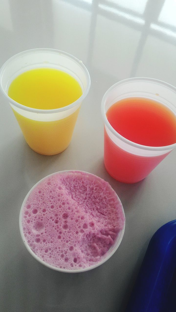 High angle view of various drinks in disposable glass