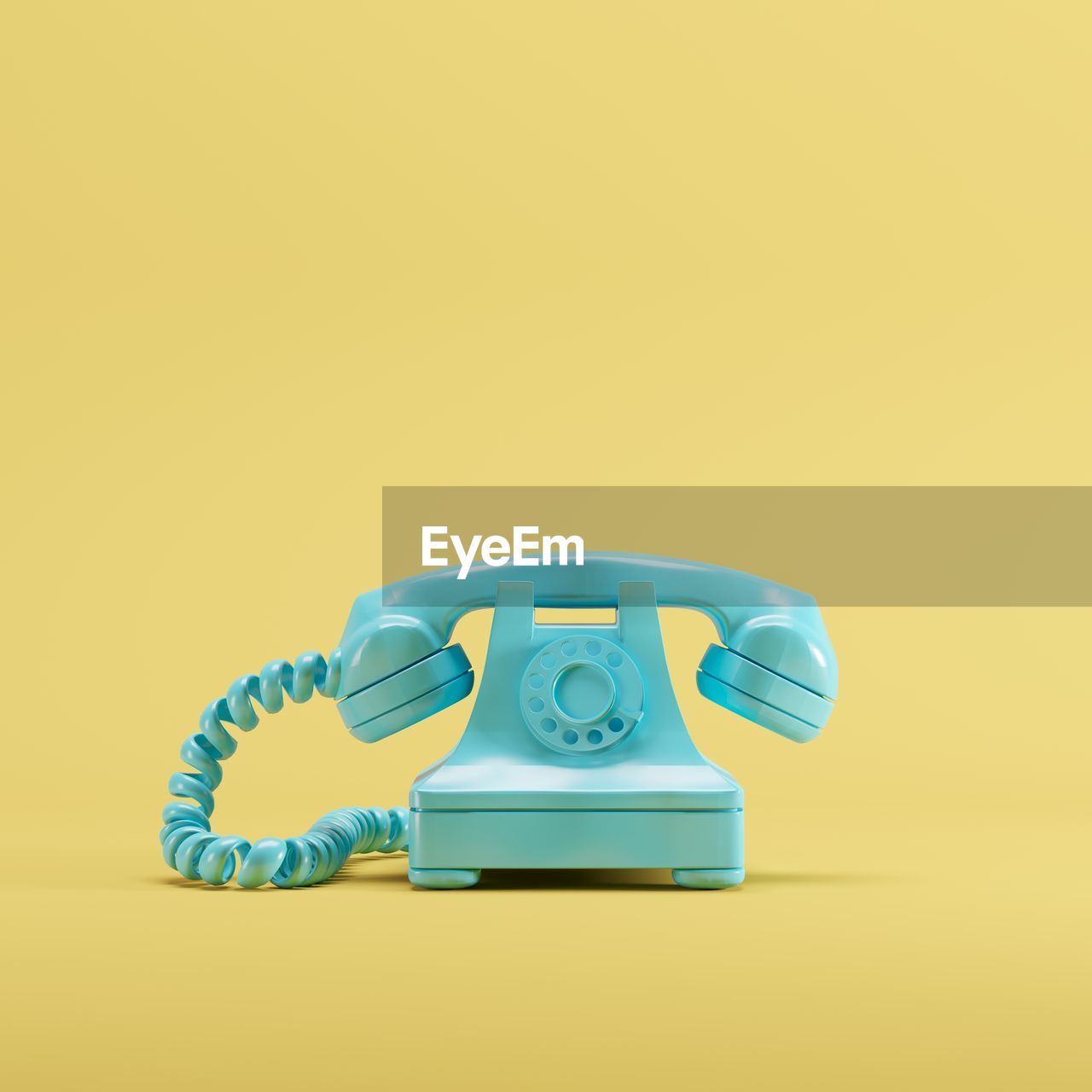 Close-up of telephone against yellow background