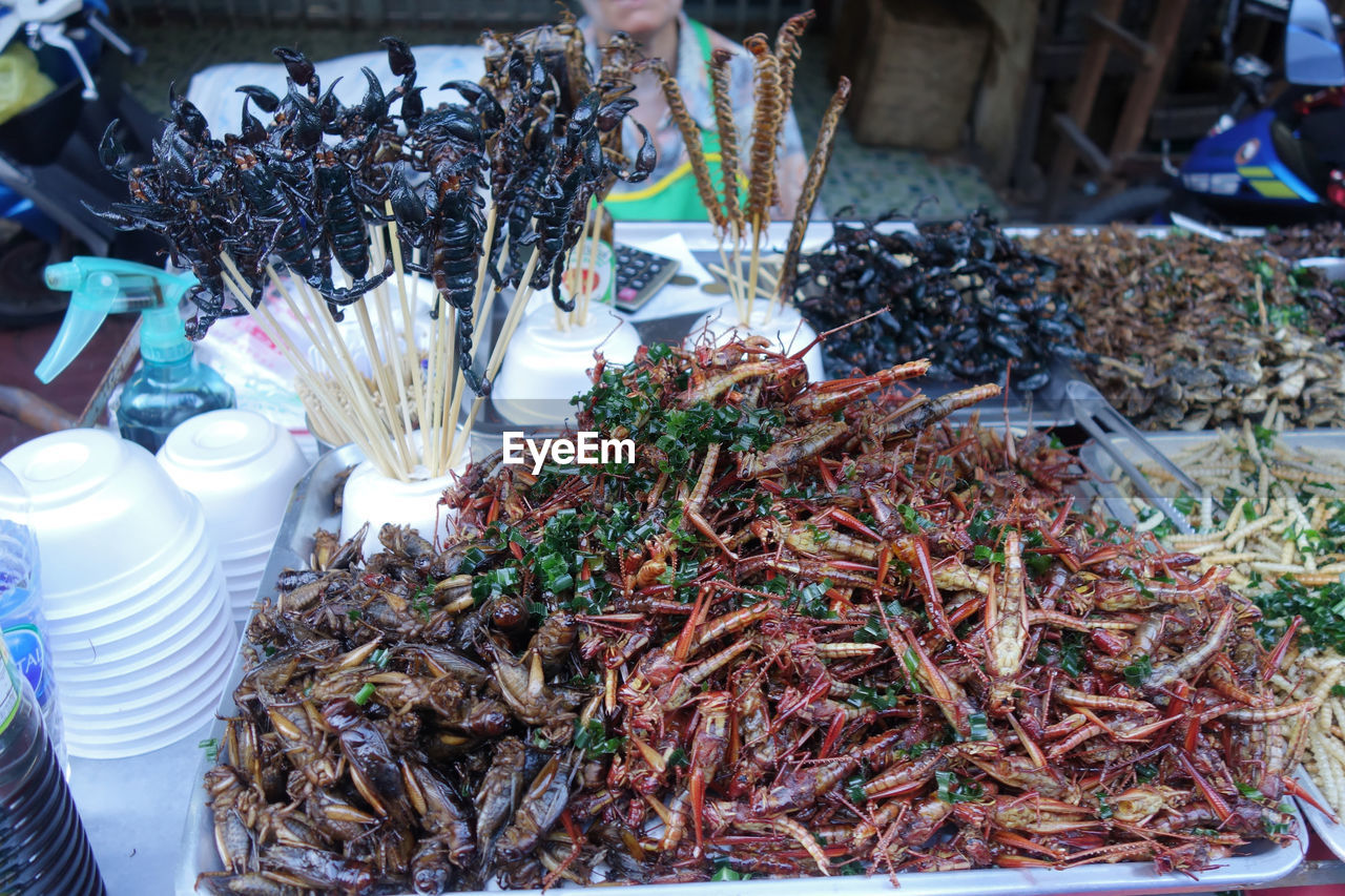 food and drink, market, food, market stall, public space, for sale, retail, abundance, large group of objects, freshness, business, city, variation, seafood, high angle view, container, day, person, business finance and industry, small business, animal, selling, outdoors, fish, wellbeing, heap, healthy eating, arrangement