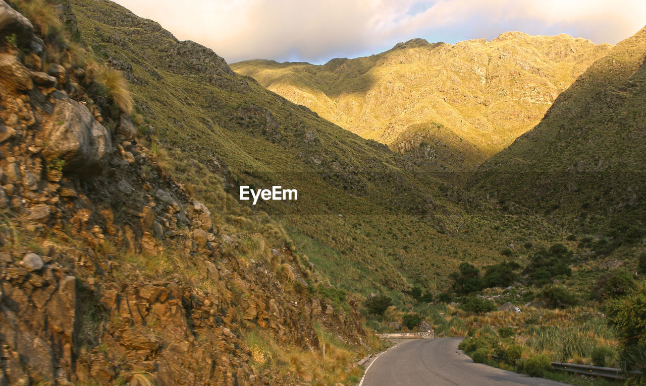 Road amidst mountains against sky