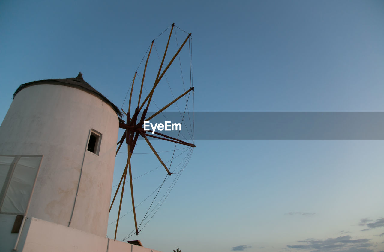 LOW ANGLE VIEW OF TRADITIONAL WINDMILL AGAINST CLEAR SKY