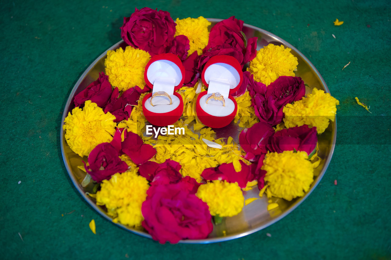 flower, yellow, indian food, flowering plant, multi colored, high angle view, petal, religion, no people, freshness, food, bowl, tradition, diwali, food and drink, belief, plant, close-up