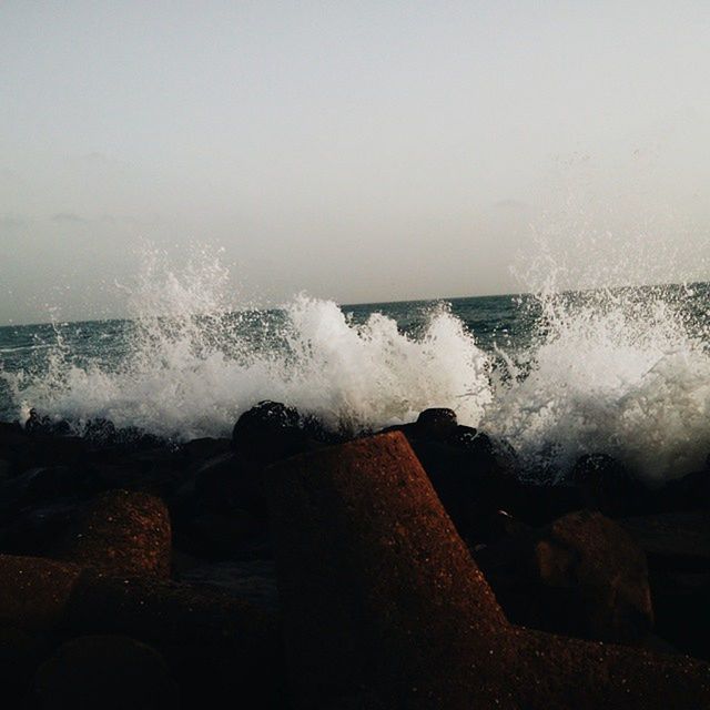 WAVES SPLASHING ON ROCKS AT SHORE