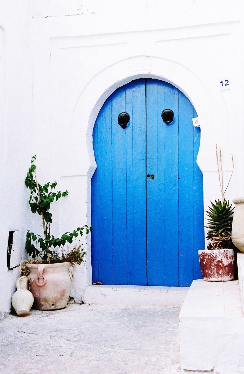 Exterior of house with closed blue door