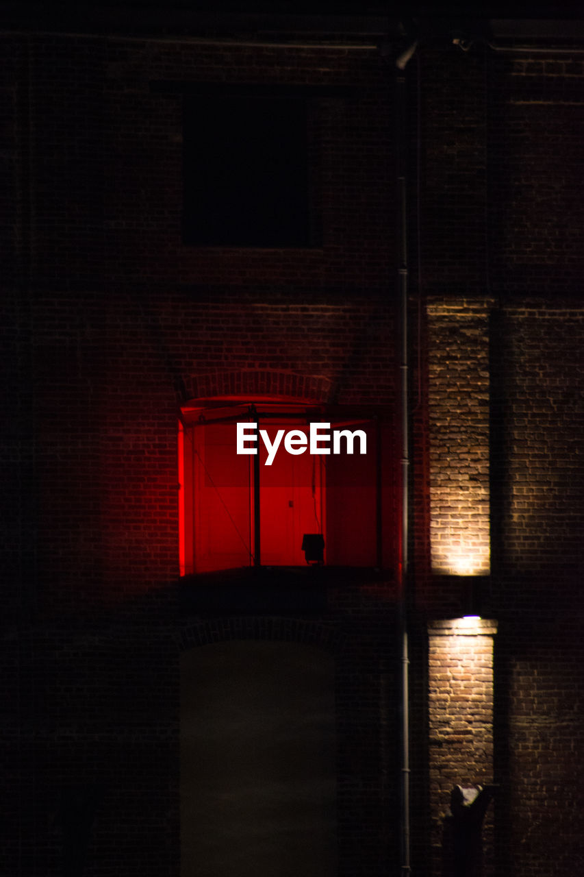 CLOSE-UP OF BRICK WALL WITH CLOSED DOOR