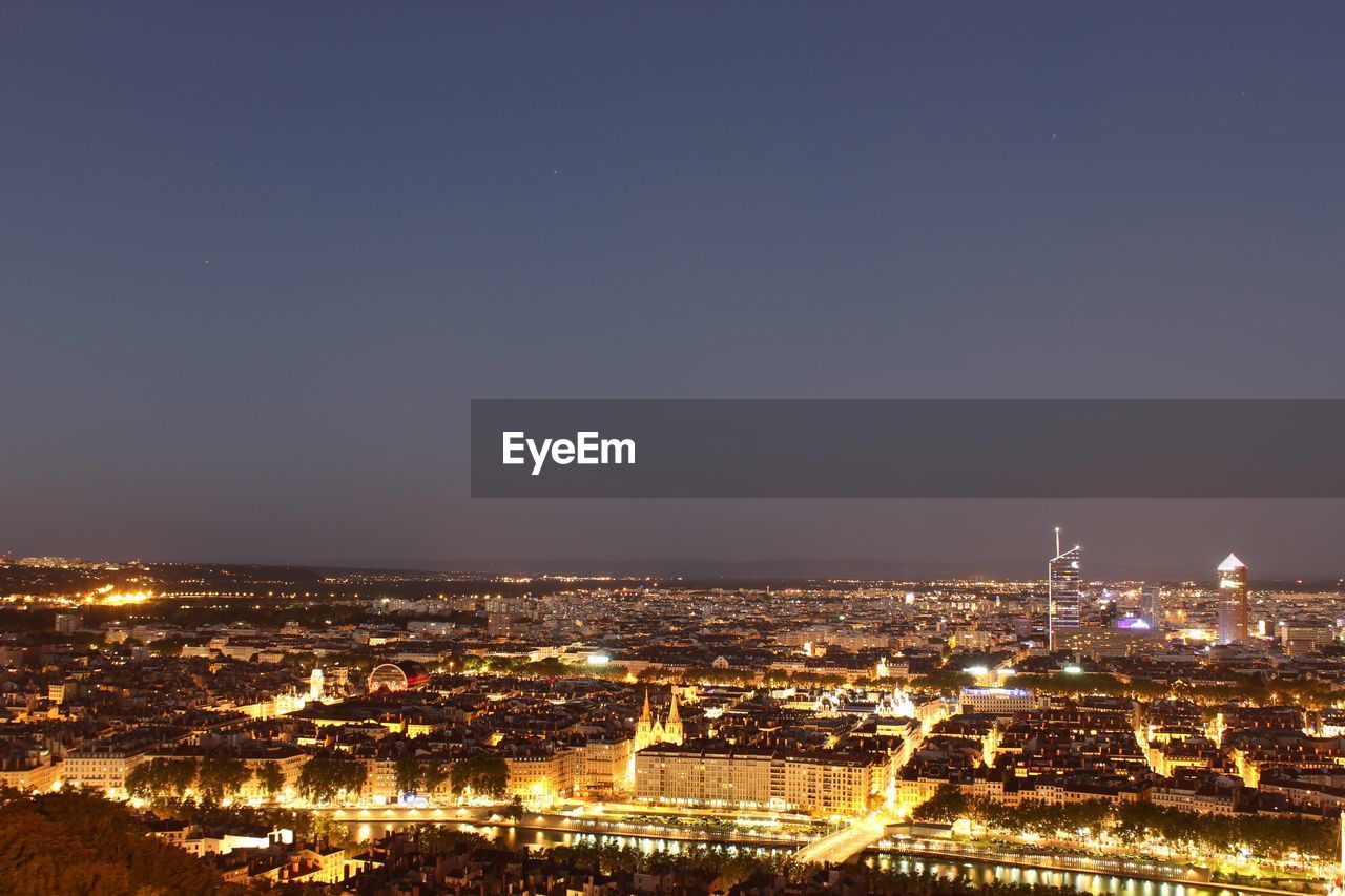 Aerial view of city lit up at night