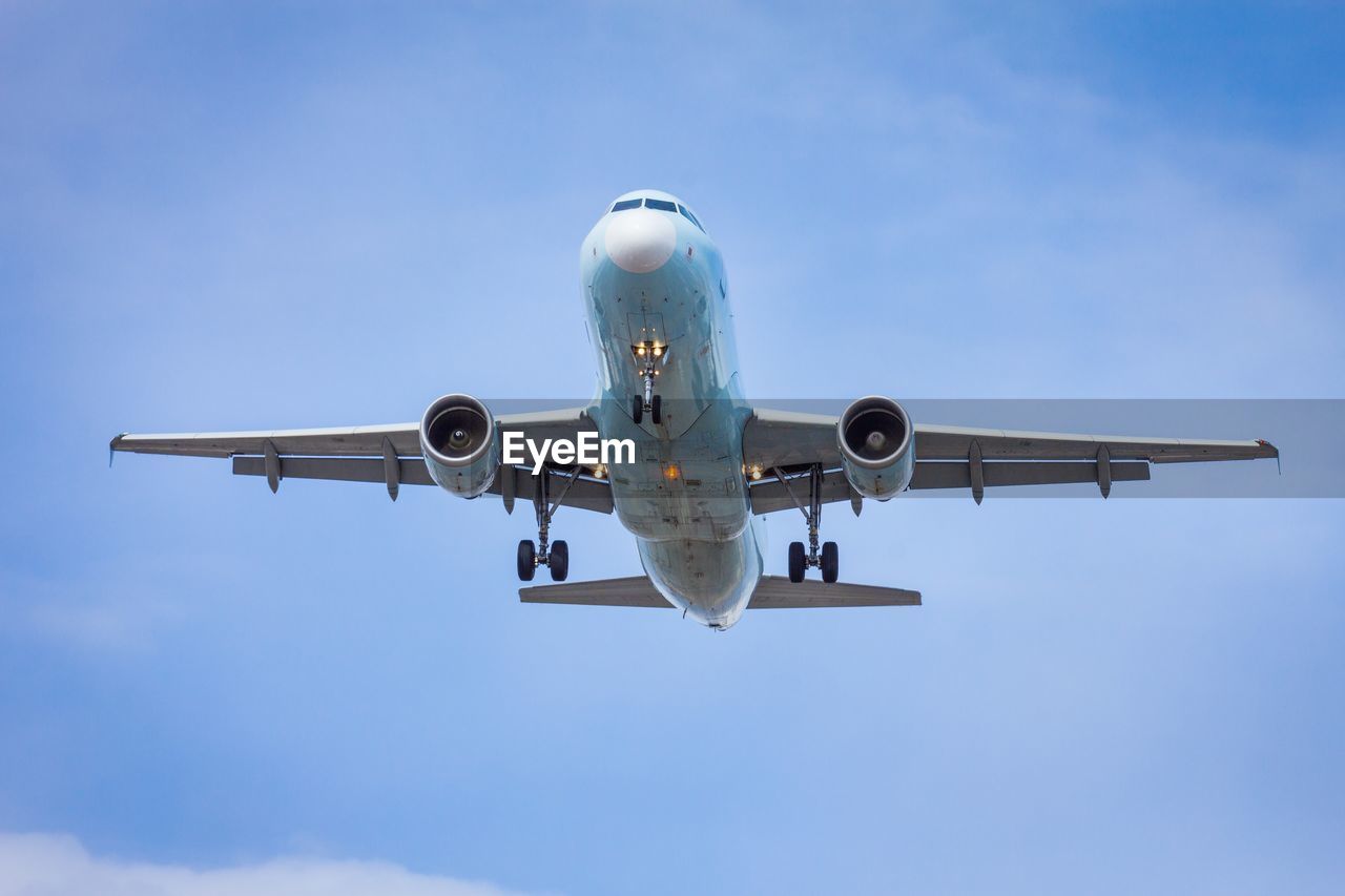 LOW ANGLE VIEW OF AIRPLANE AGAINST SKY