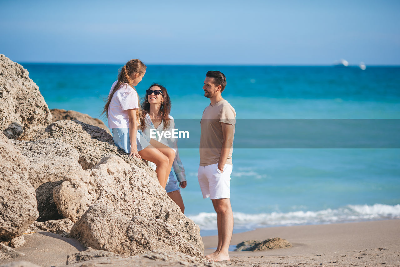 rear view of woman standing on beach