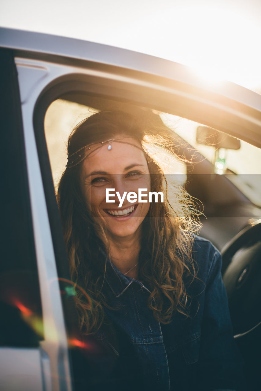 Portrait of smiling young woman in car