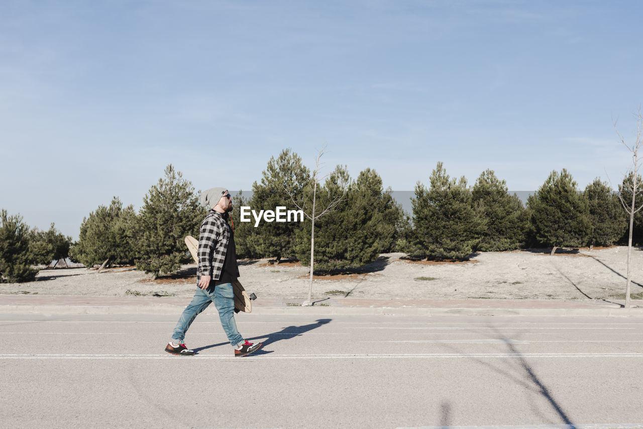 Man walking with his longboard