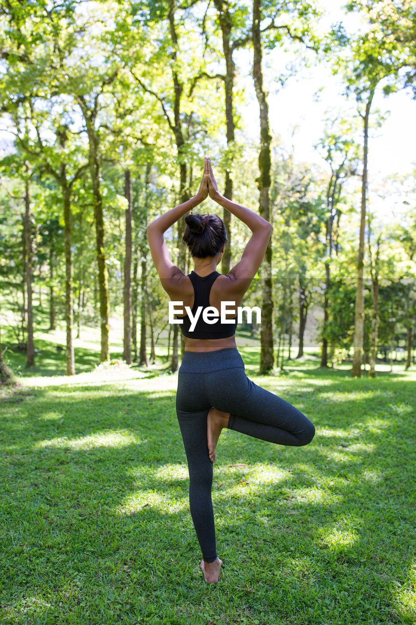 Full length of woman exercising at park