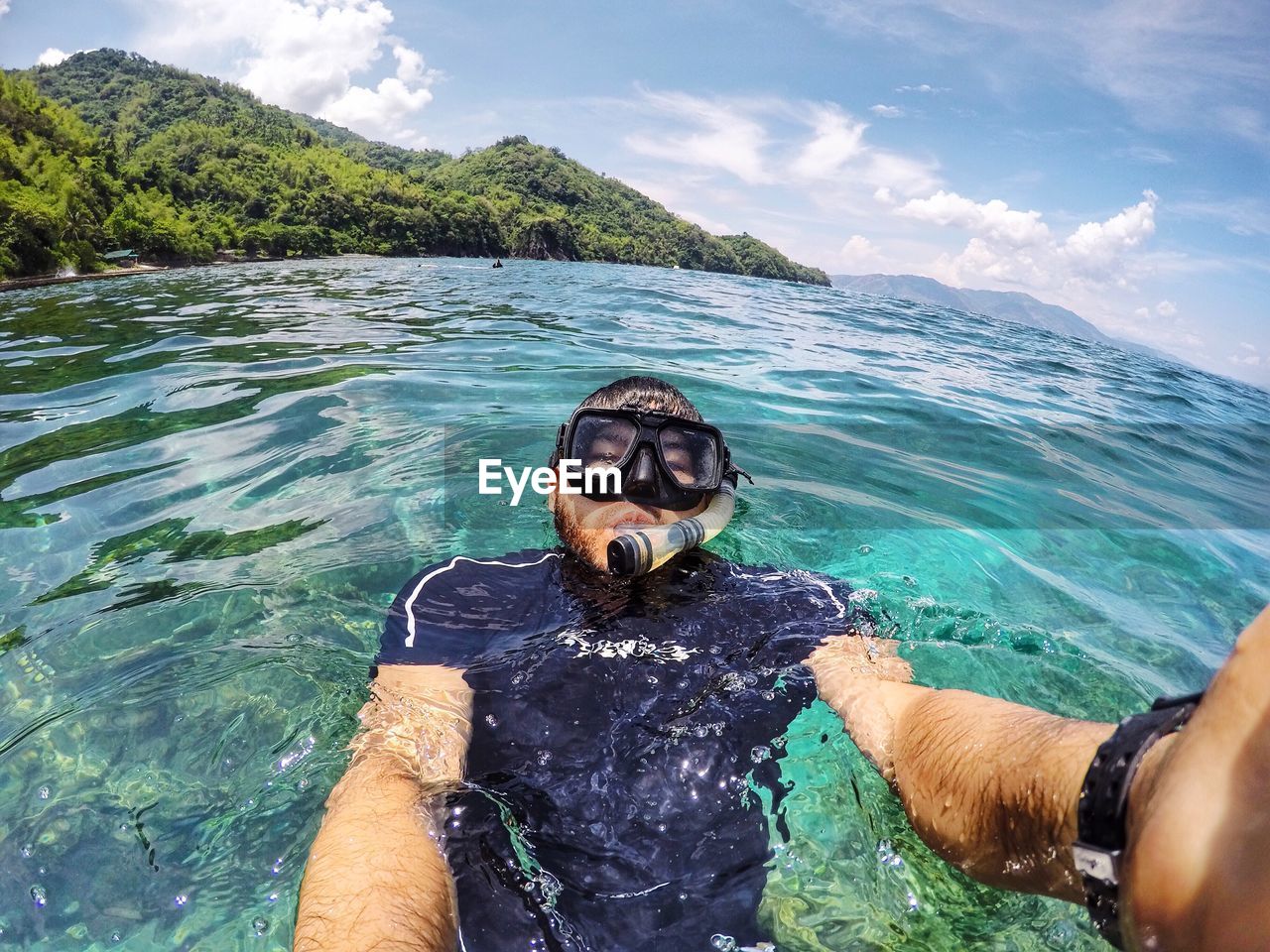 YOUNG MAN LOOKING AT SEA