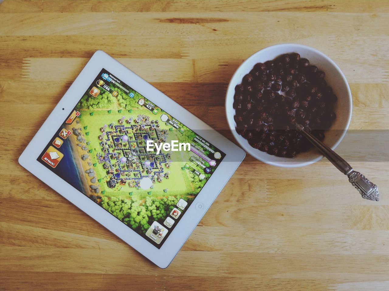 Tablet beside bowl of cereal