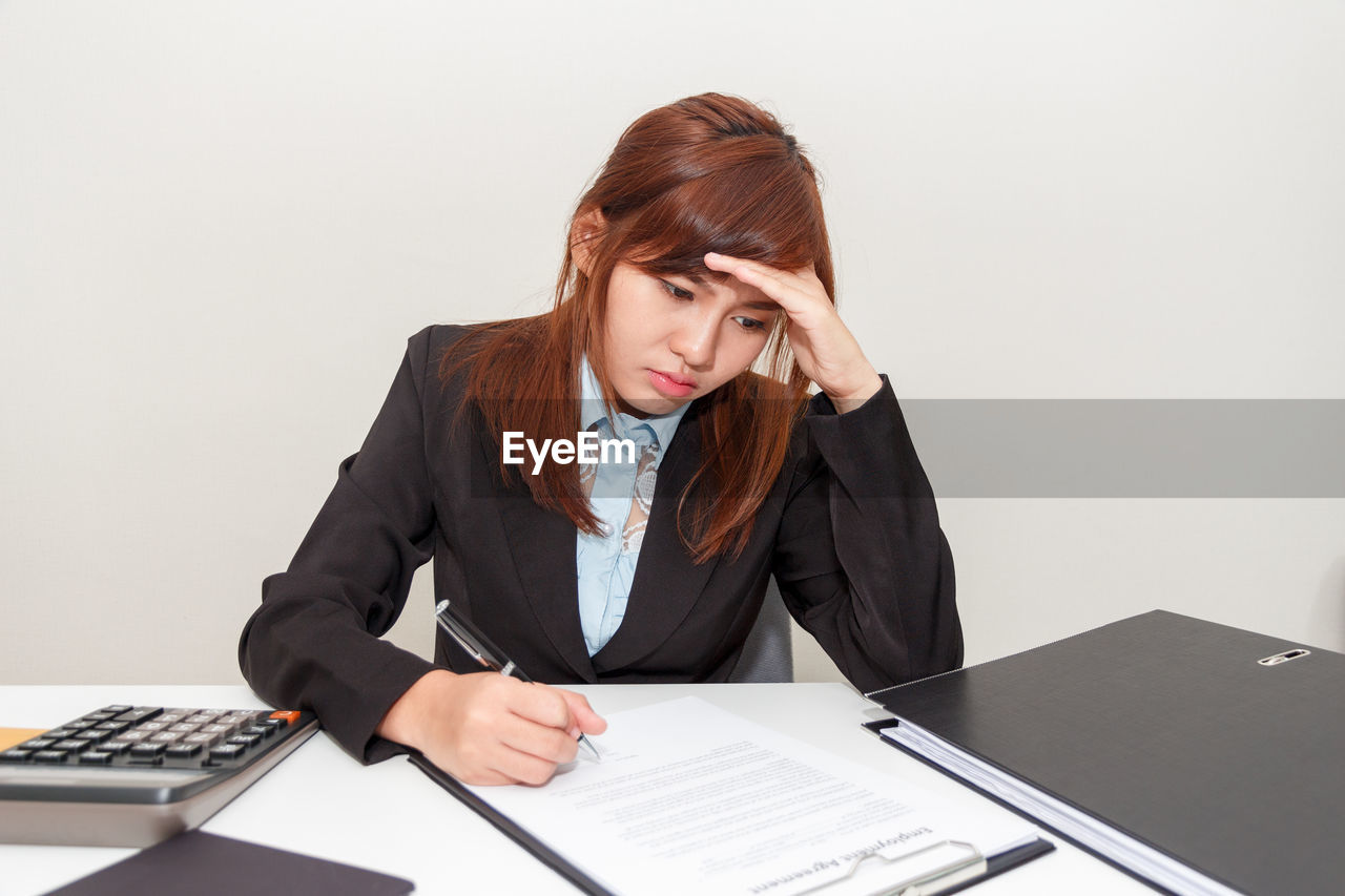 Stressed businesswoman working in office