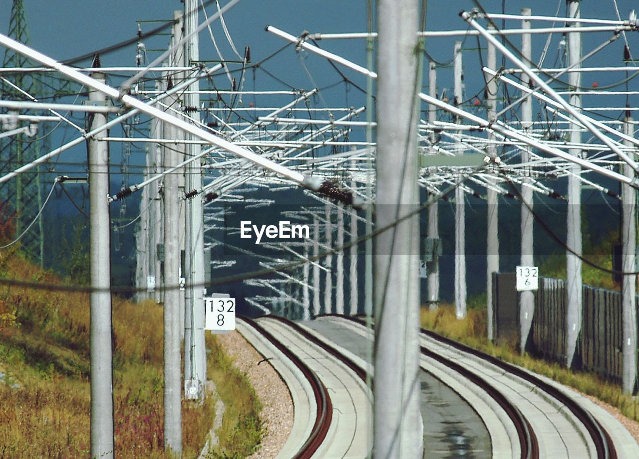 Railroad tracks by electricity pylon