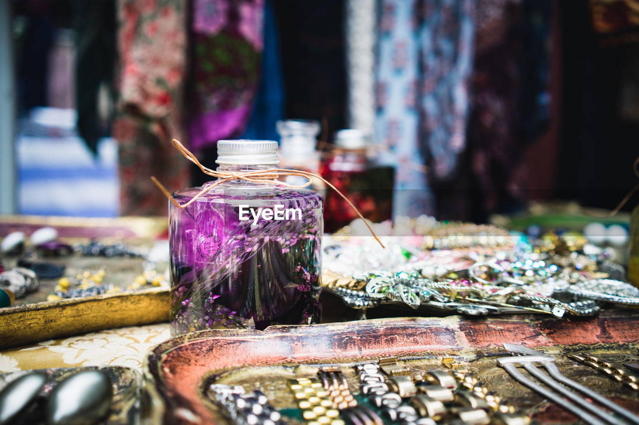 CLOSE-UP OF MULTI COLORED JAR ON TABLE